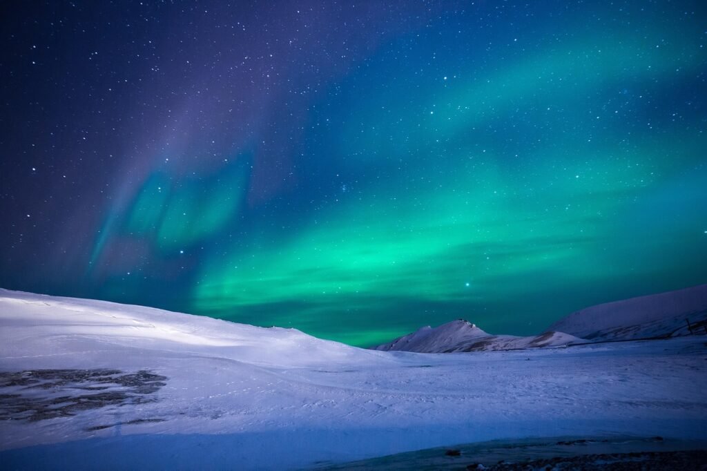 Northern Lights in Canada over snowy mountains