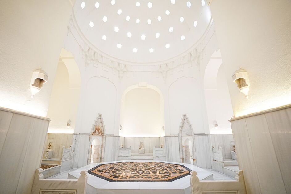 Visitors enjoying a traditional Turkish hammam with steam rooms and marble interiors in Turkey.