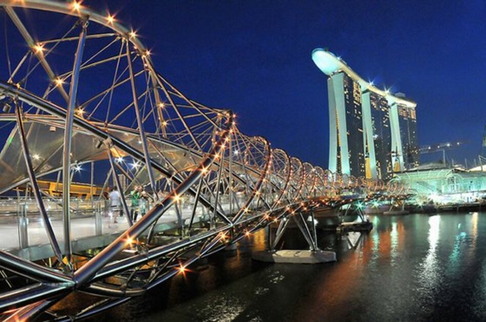 Helix Bridge in Singapore illuminated at night near Marina Bay, a popular attraction and top thing to do in Singapore